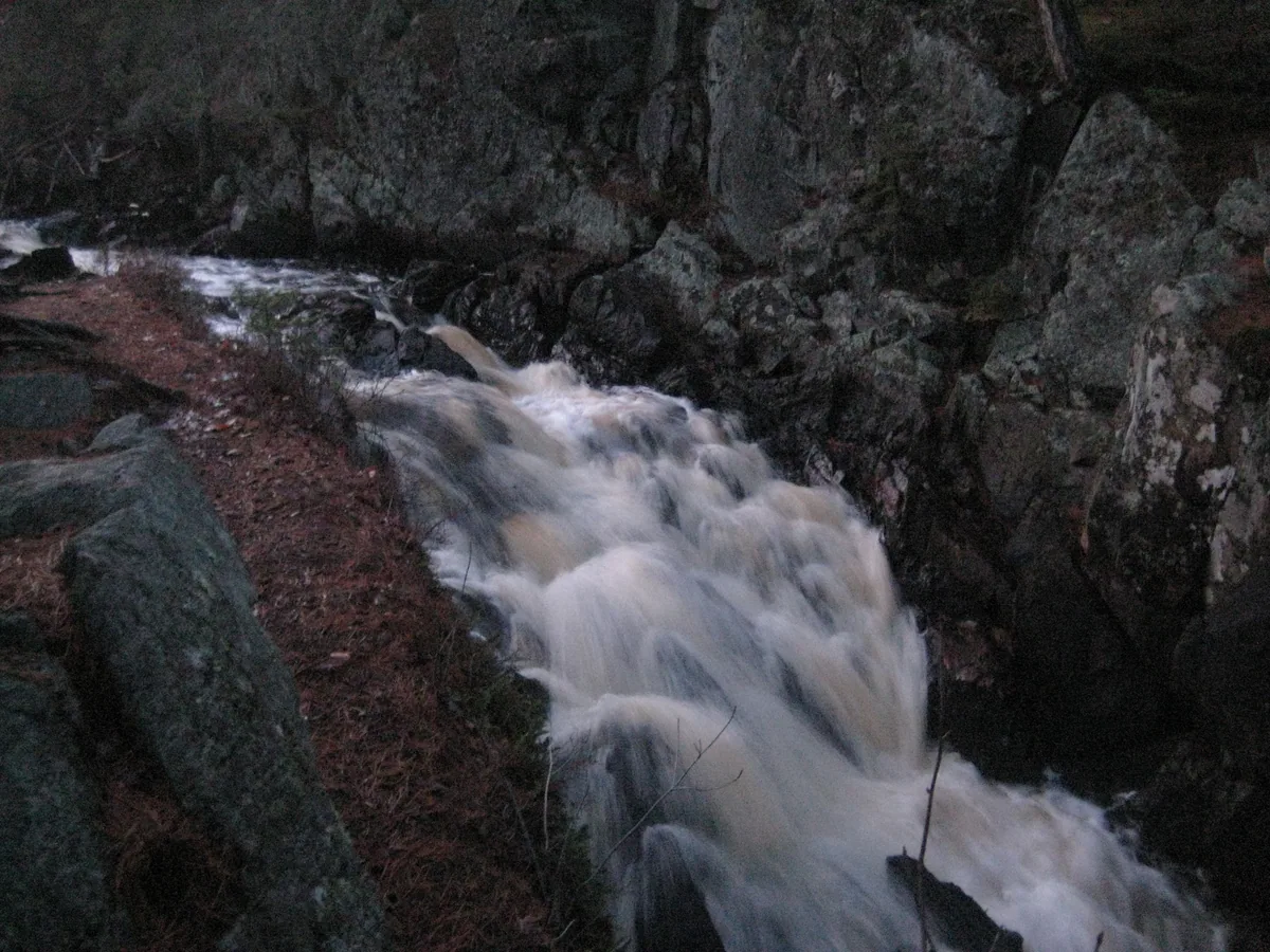 Looking down at the dim chute below