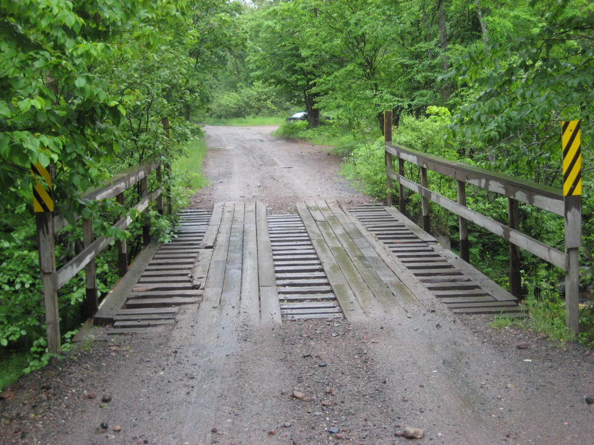 Wet wooden bridge over the river