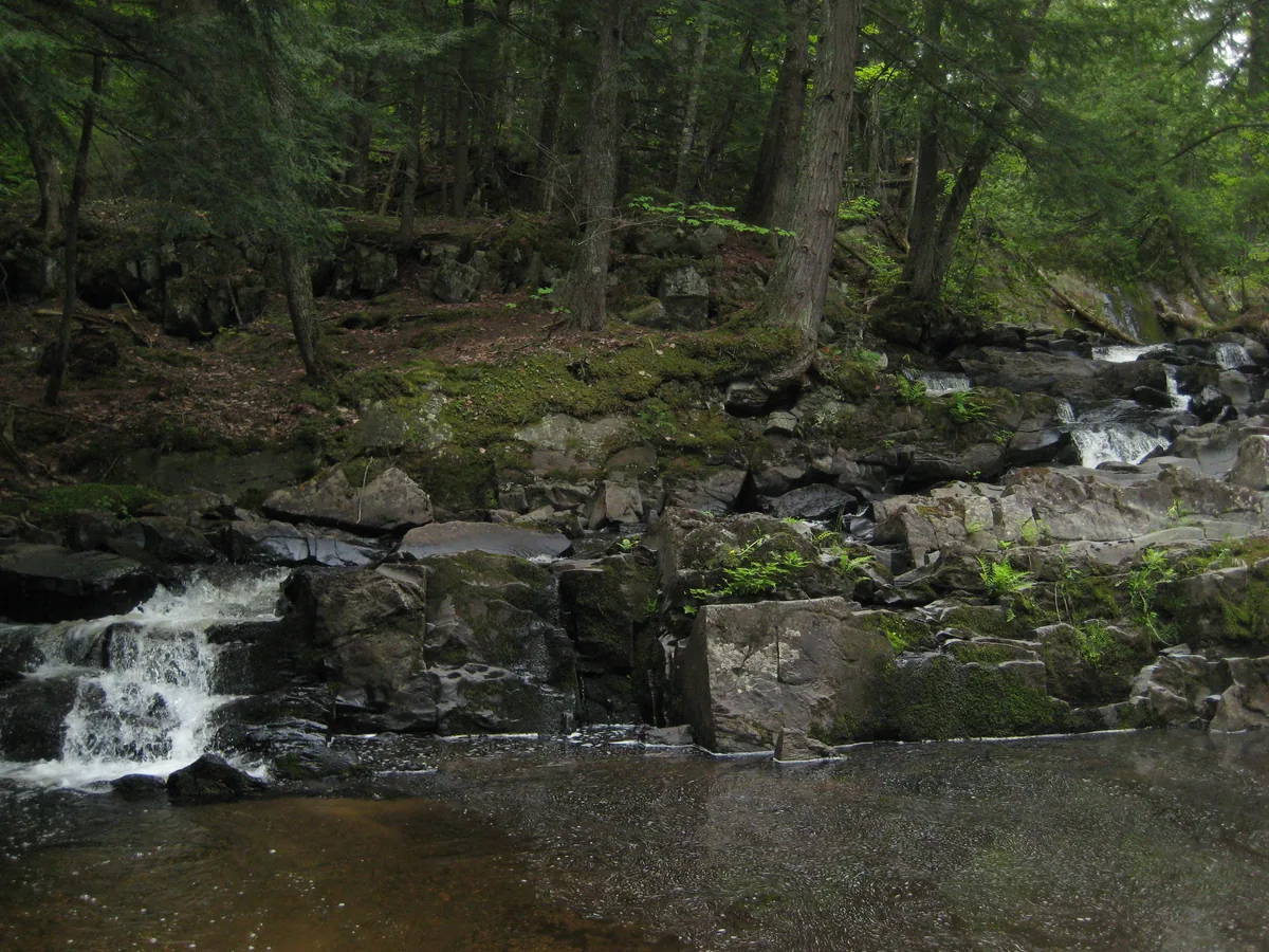 Blocky rocks pushing the water over