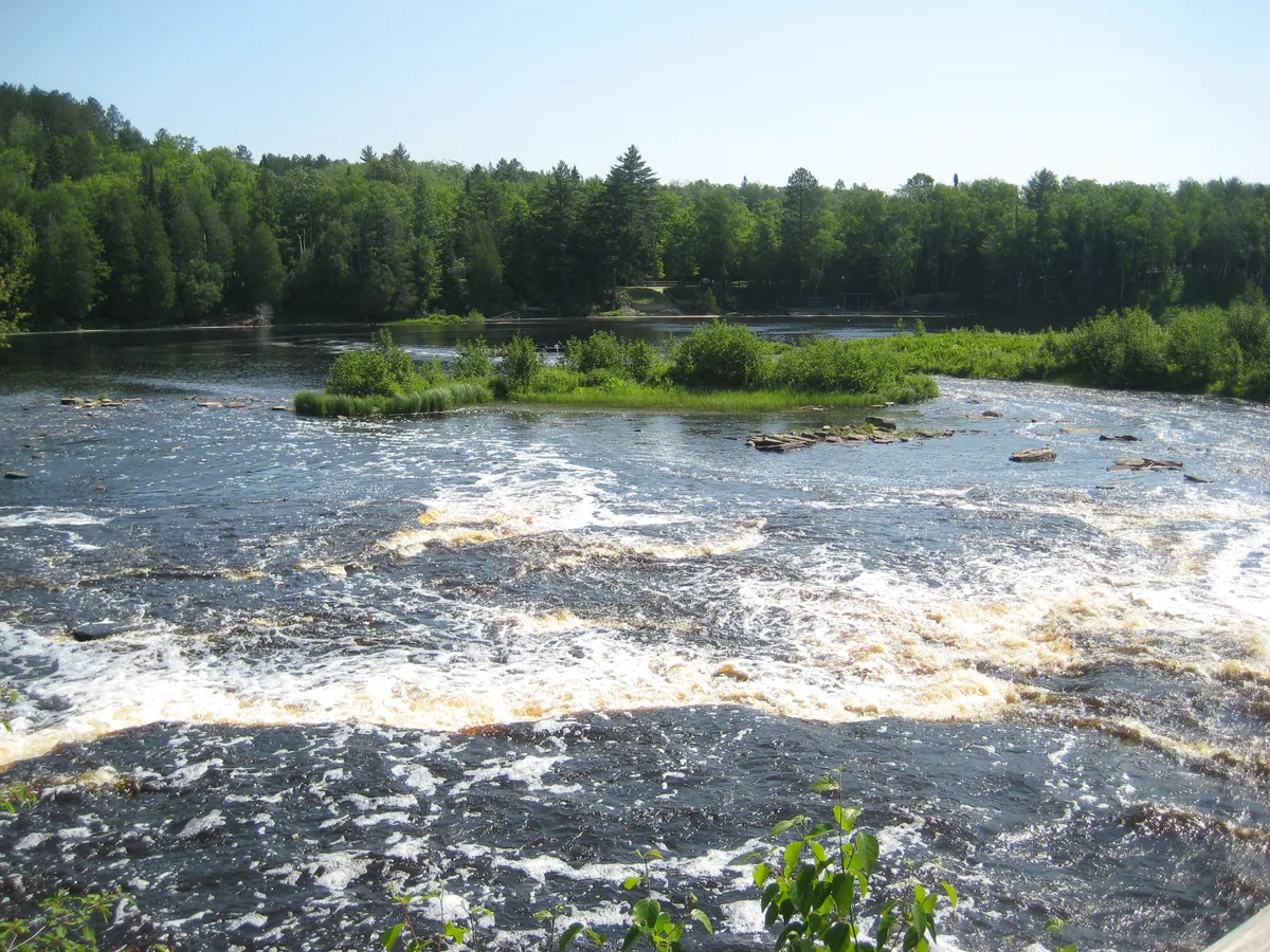 Looking down the swirling brown waters