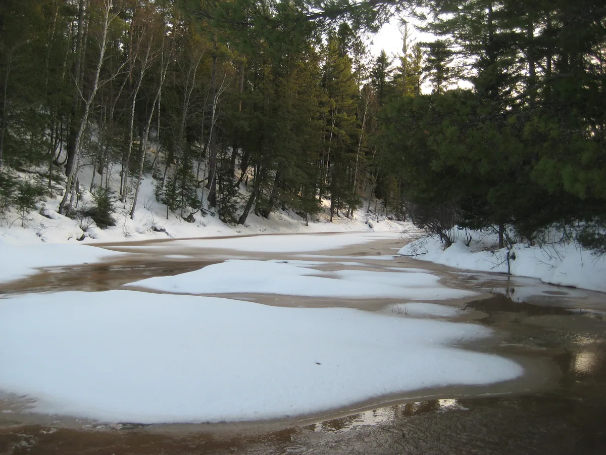 Brown slush over the water