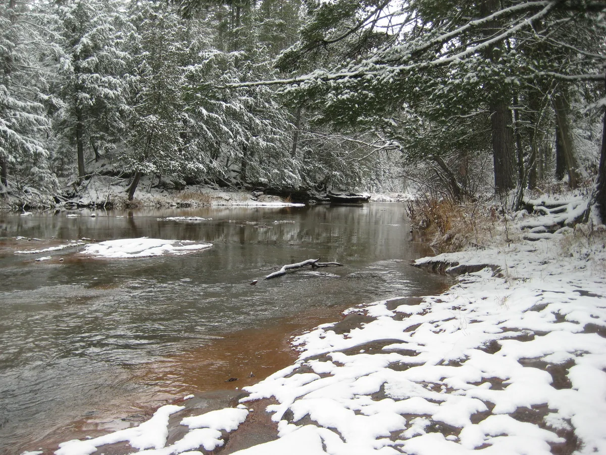 Calm river between snowy banks