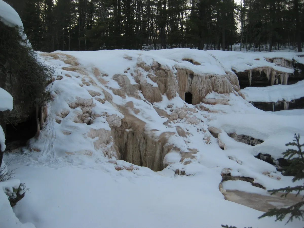 Muddy stacks of ice hiding the falls