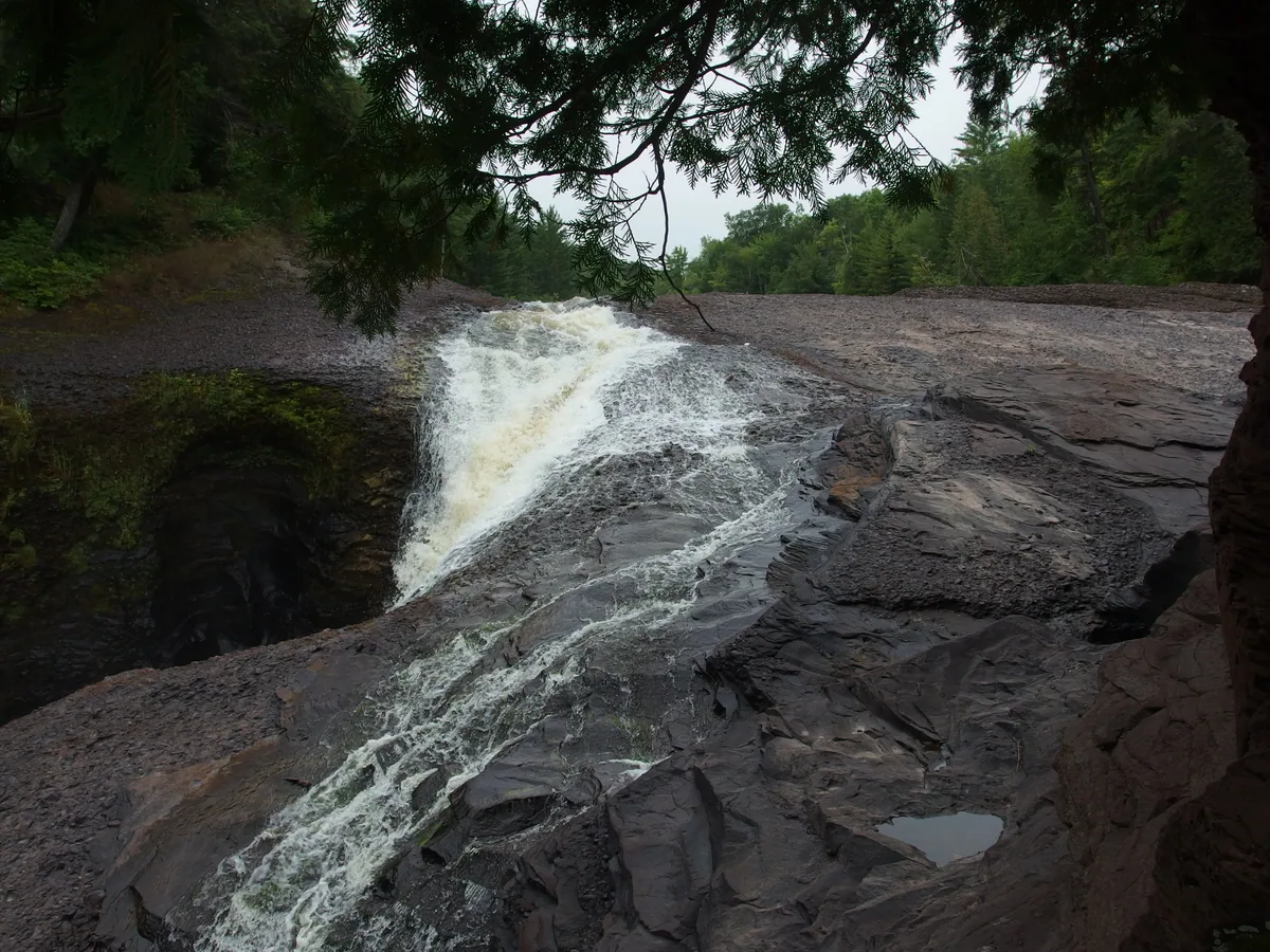 Shy Rainbow Falls pouring over the lip