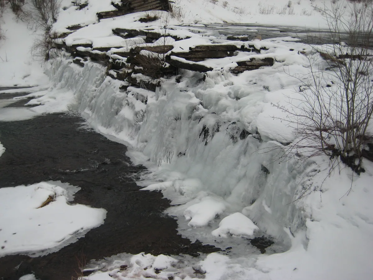 Ice coating the timber crib dam