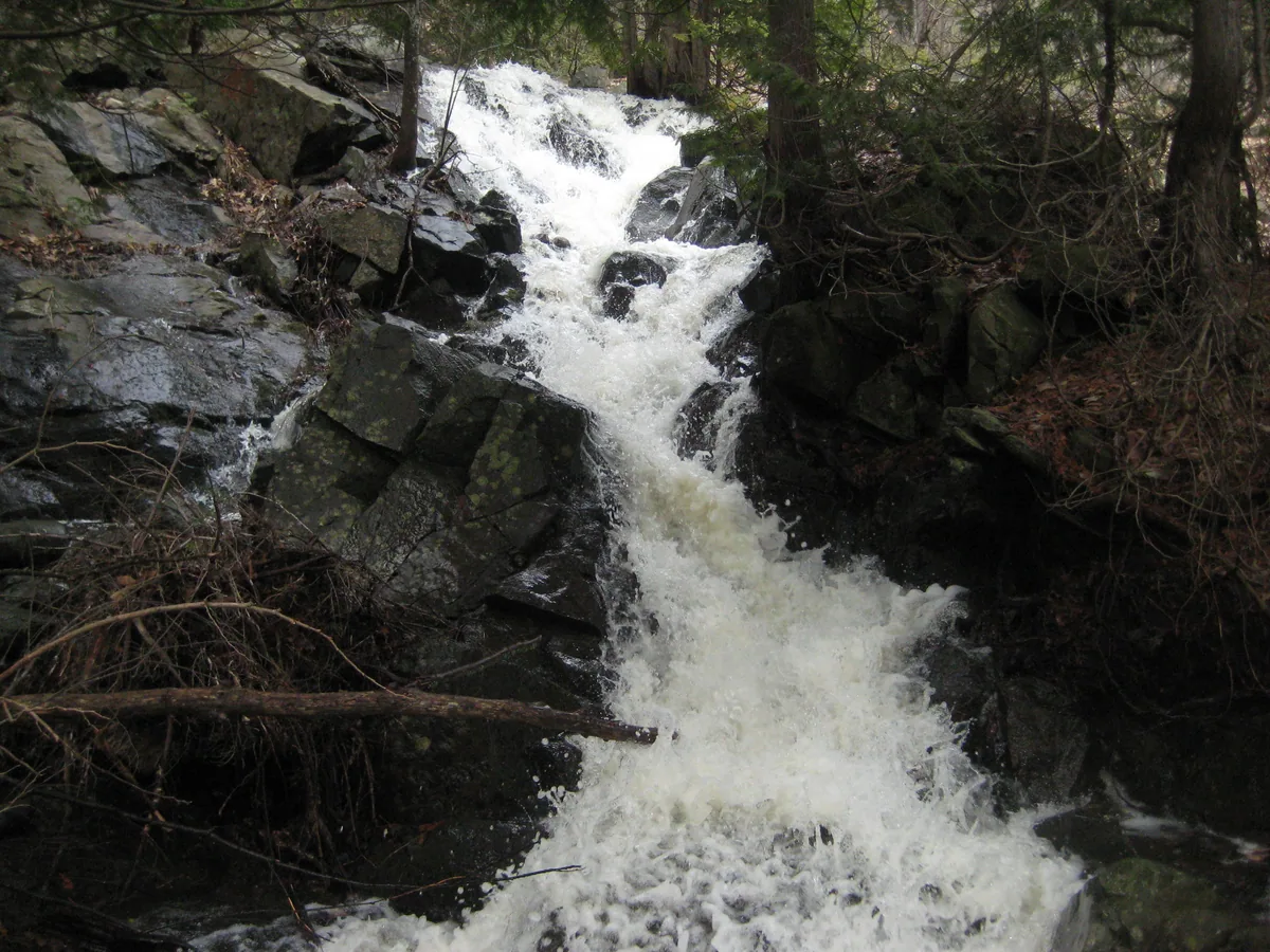 Angry foaming waters over black rocks