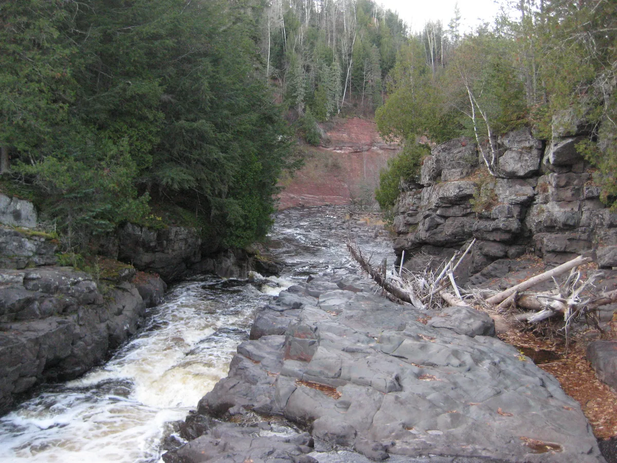 Sandstone wall beyond the falls