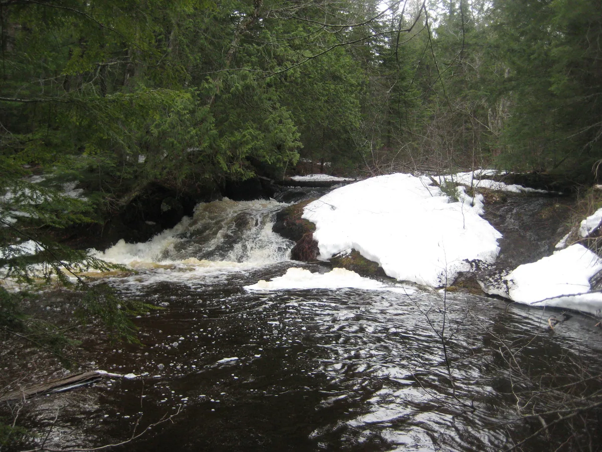 Snowy drop into a deep pool