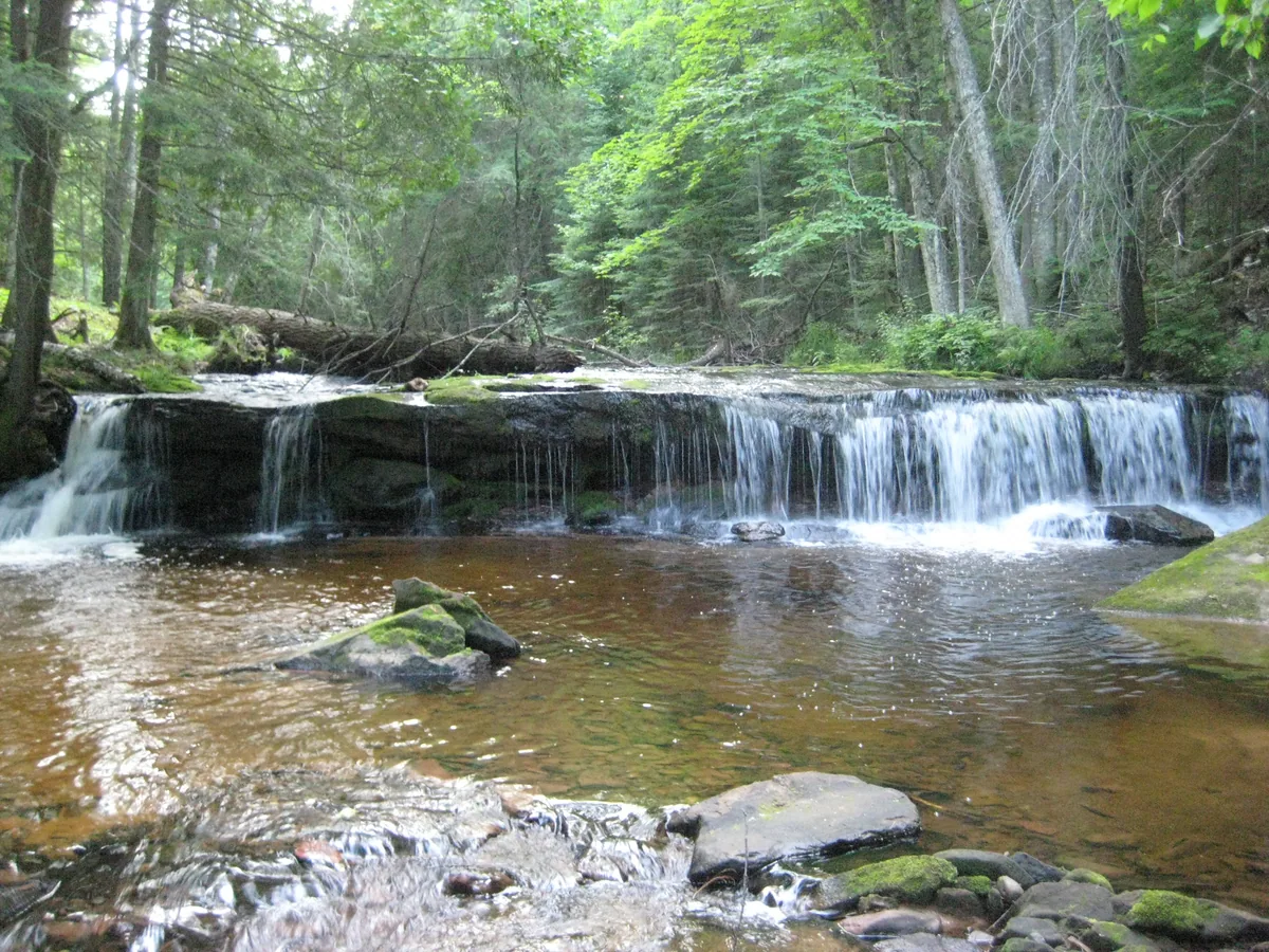 Overhanging ledge creating a small waterfall