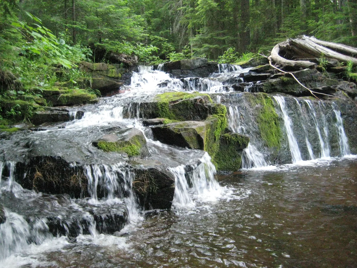 Outstretched leg on the left side of the falls