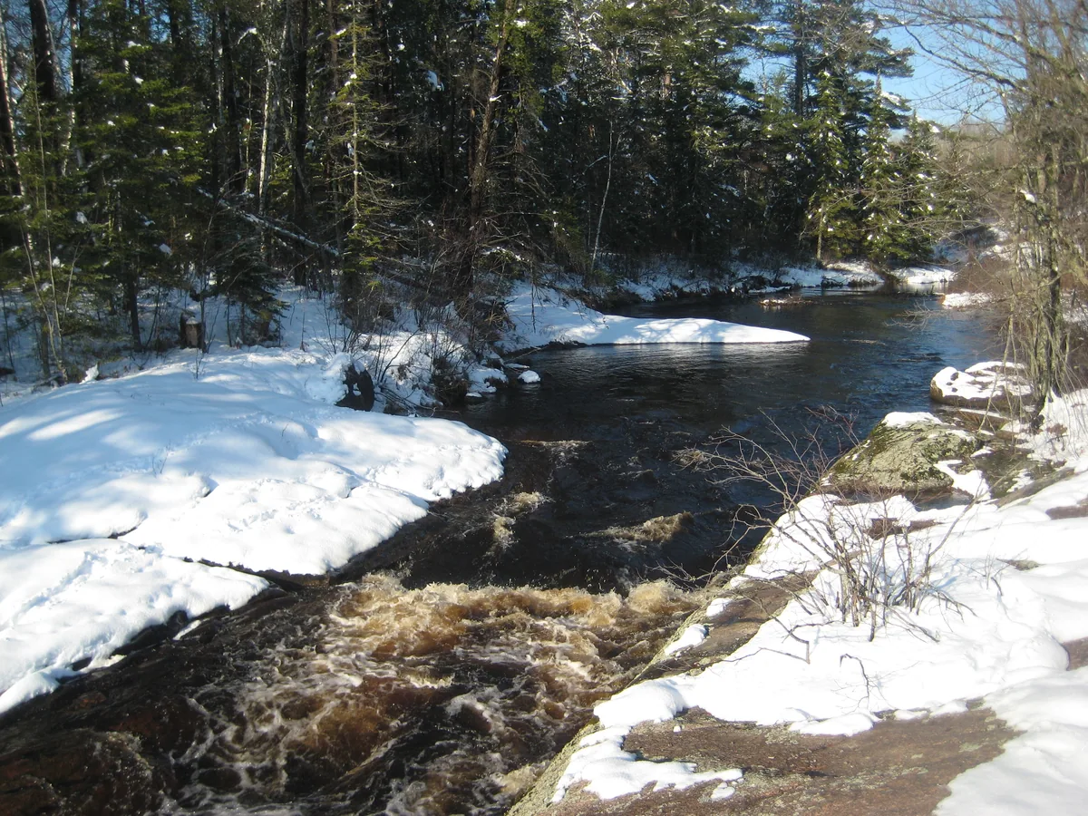 Peering upstream beyond the waterfall