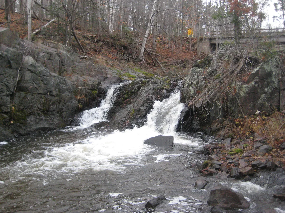 Tiny white chutes below the bridge